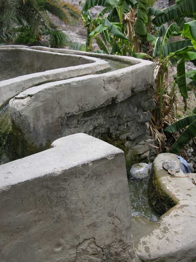 Muscat 07 05 Misfah Irrigation System Misfah abounds in greenery and date palms. The falaj system in Misfah is fascinating since the water weaves its way in a snakelike fashion along the mountain side and special channels in turn redirect the water down to different levels of the mountain side.